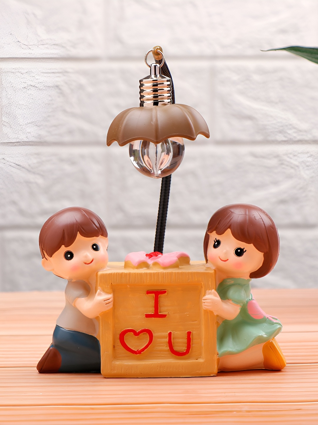 

Archies Red Couch Couple Illuminating Figurine Showpiece