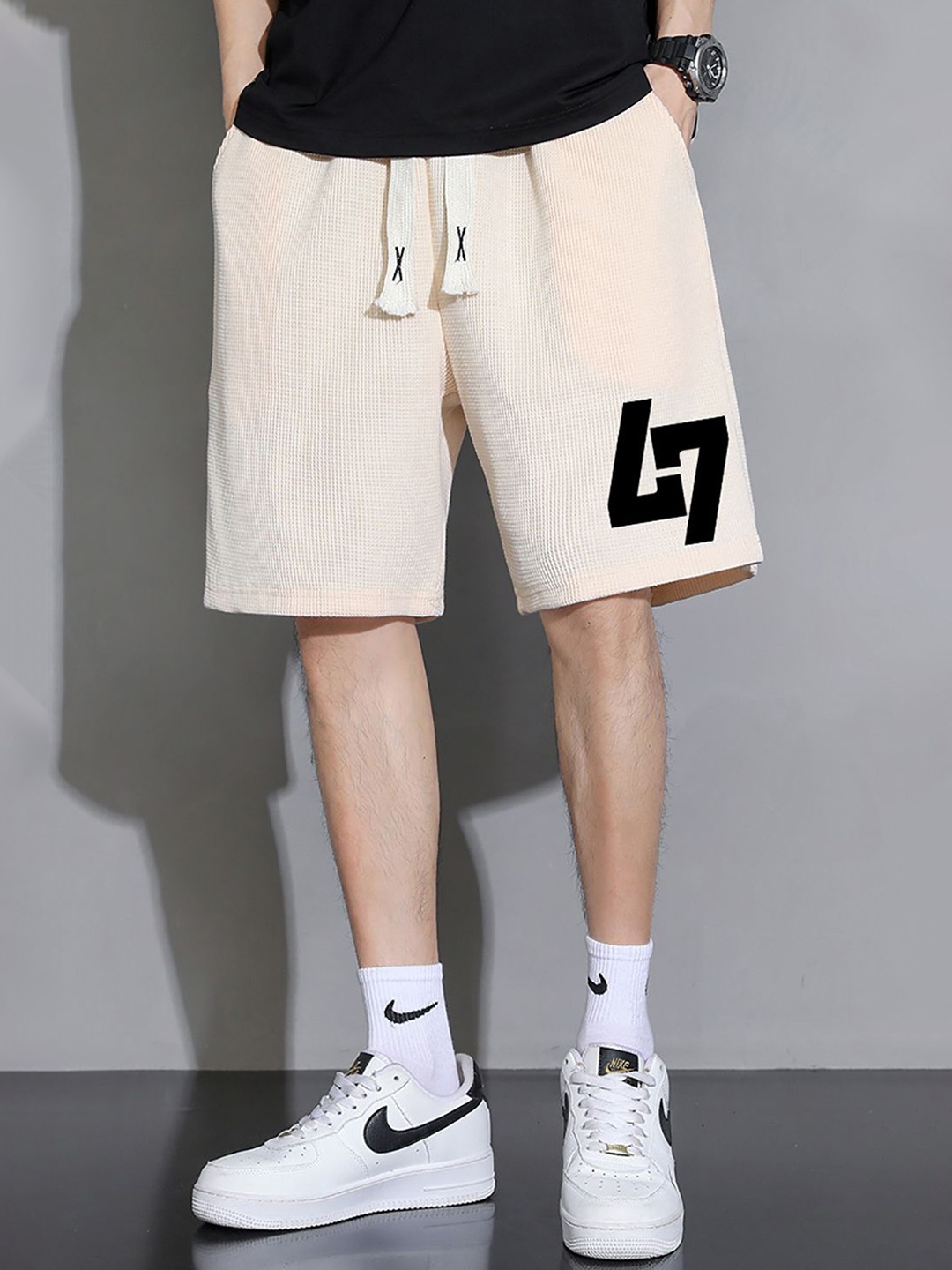 

StyleCast x Revolte Men Typography Printed Shorts, Beige