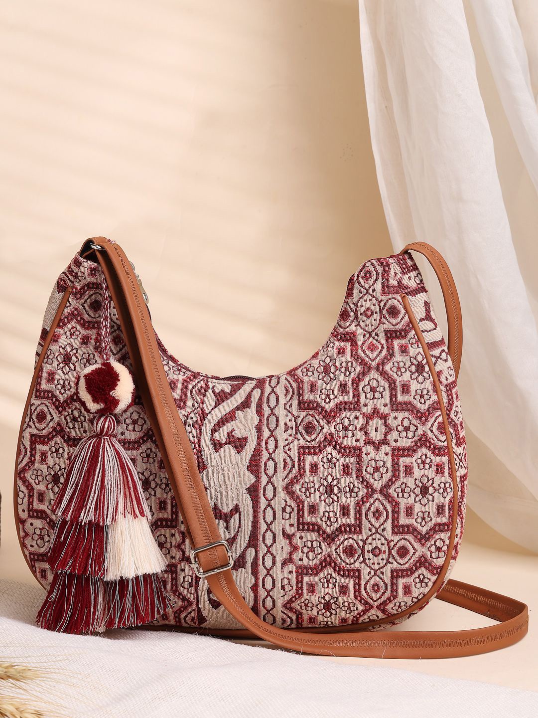 

Anekaant Geometric Structured Tasselled Detail Tribal Cotton Jacquard Sling Bag, Maroon