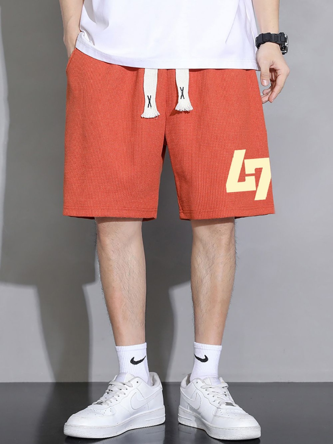 

StyleCast x Revolte Men Typography Printed Shorts, Orange