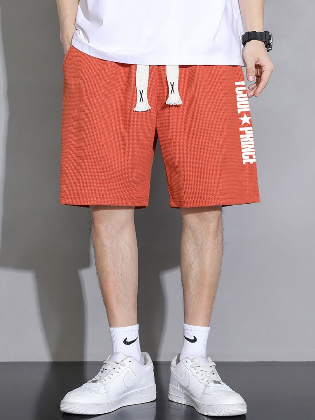 

StyleCast x Revolte Men Typography Printed Shorts, Orange