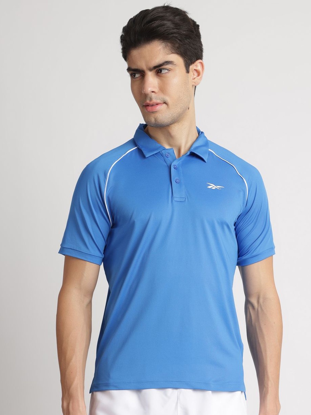 

Reebok Men Solid Raglan Sleeves Polo Collar Casual T-shirt, Blue