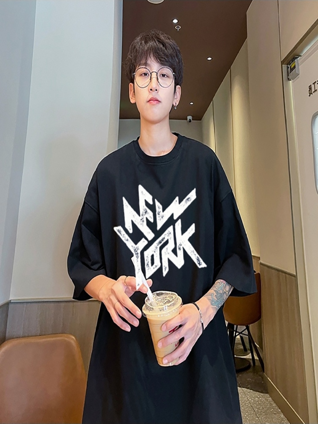 

StyleCast x Revolte Men Typography Printed Round Neck Oversized T-shirt, Black