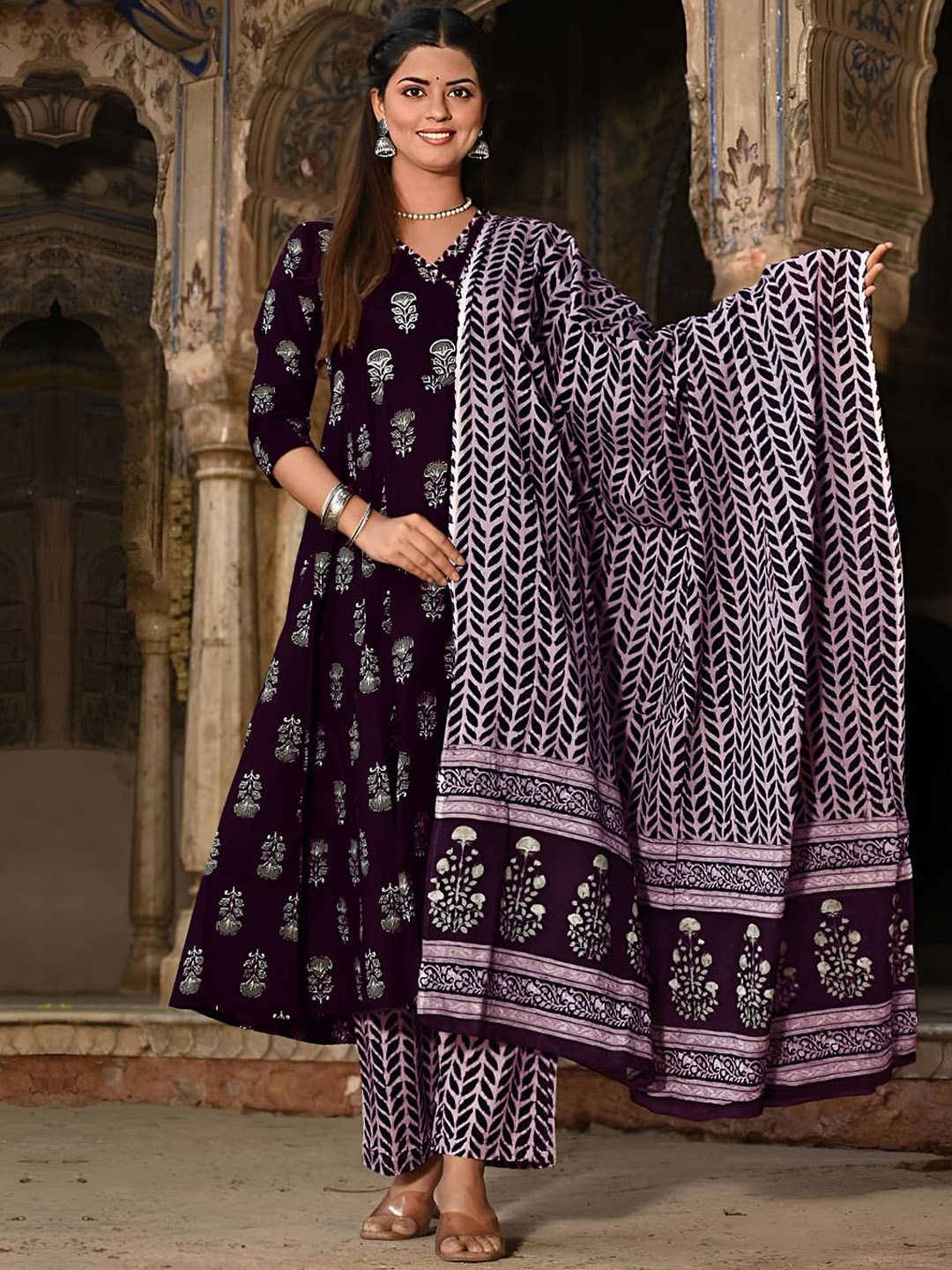 

Moda Rapido Ethnic Motifs Printed V-Neck Empire Anarkali Kurta With Trouser And Dupatta, Purple