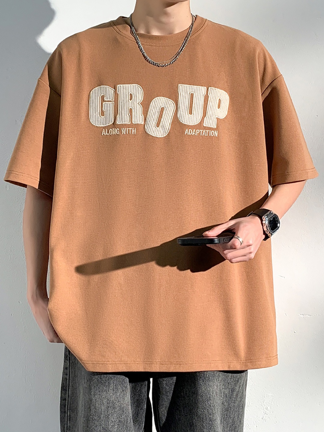 

StyleCast x Revolte Men Typography Printed Round Neck Oversized T-shirt, Brown