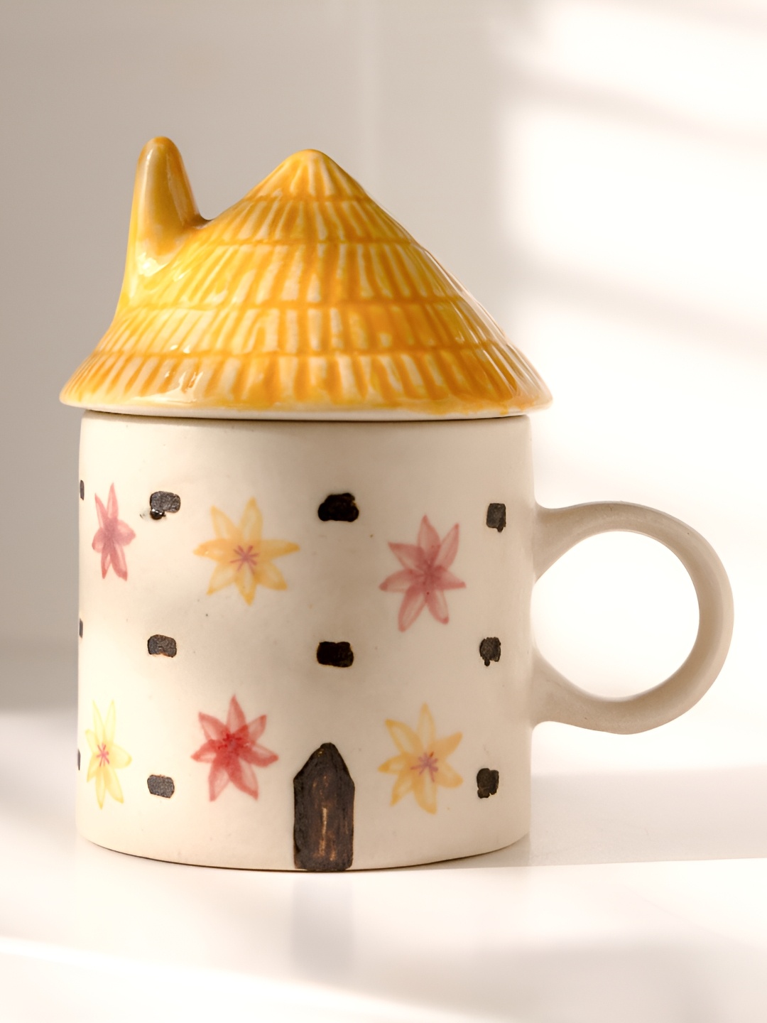 

THE INDIAN ROSE Blooms and Tales White Printed Ceramic Matte Roof Hut Shape Mug-175 ml