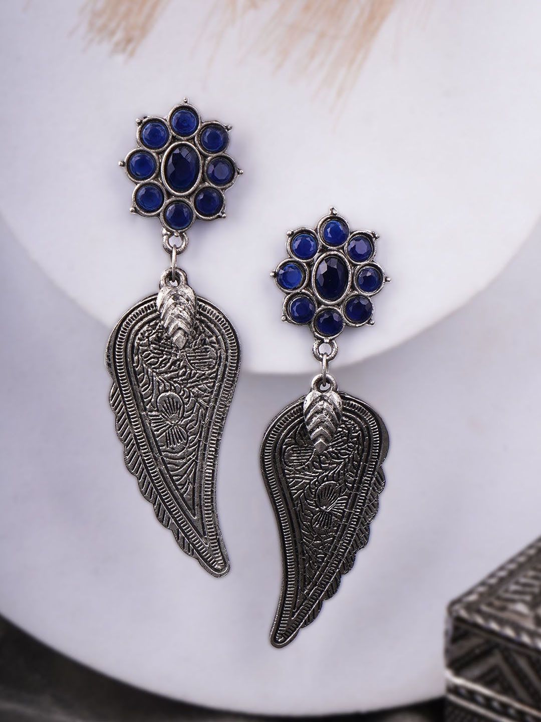 

Sangria Blue Silver-Plated Artificial Stones Studded Leaf Shaped Oxidised Drop Earrings