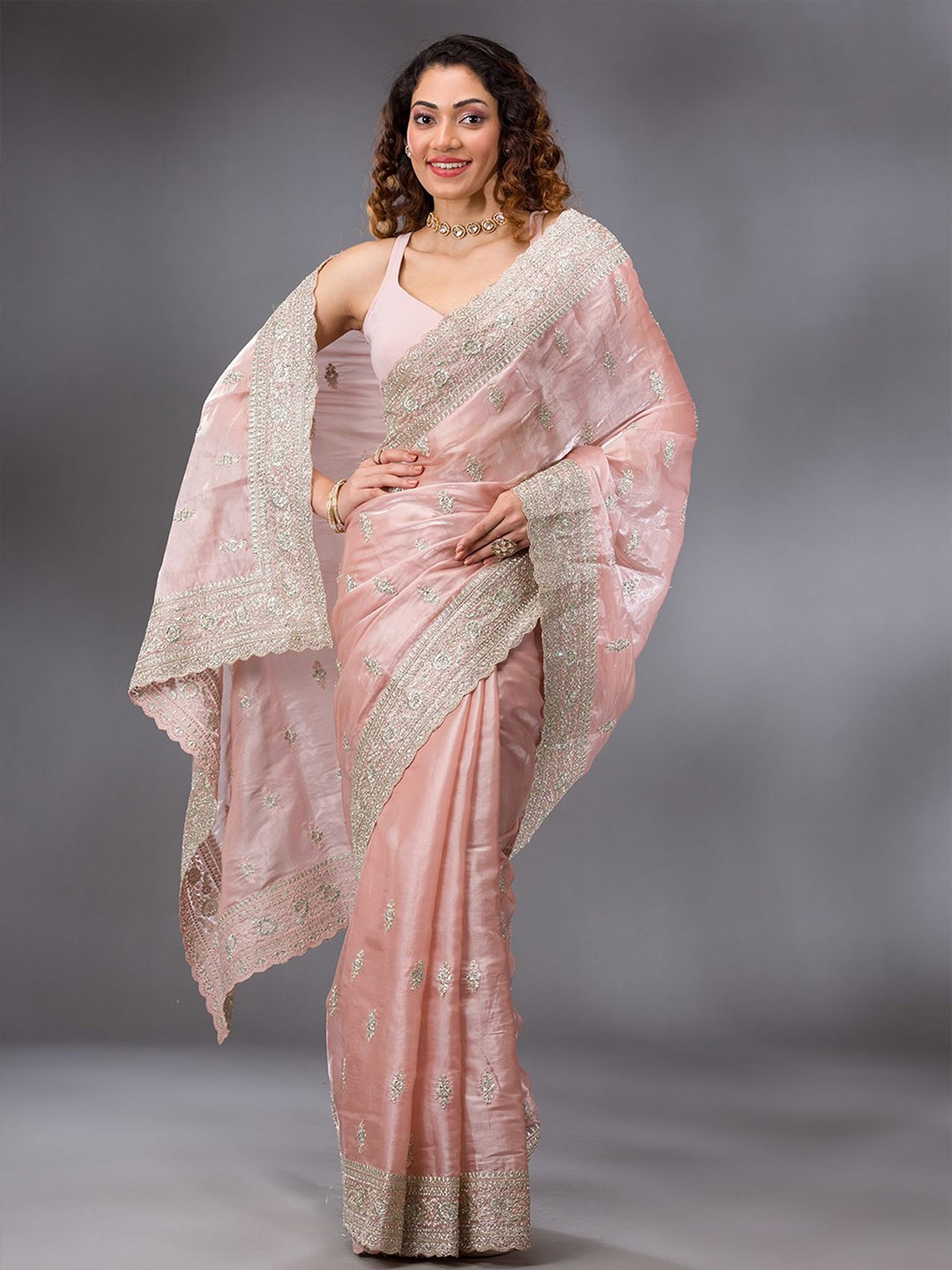 

Koskii Embellished Peach Zari work Semi Crepe Saree