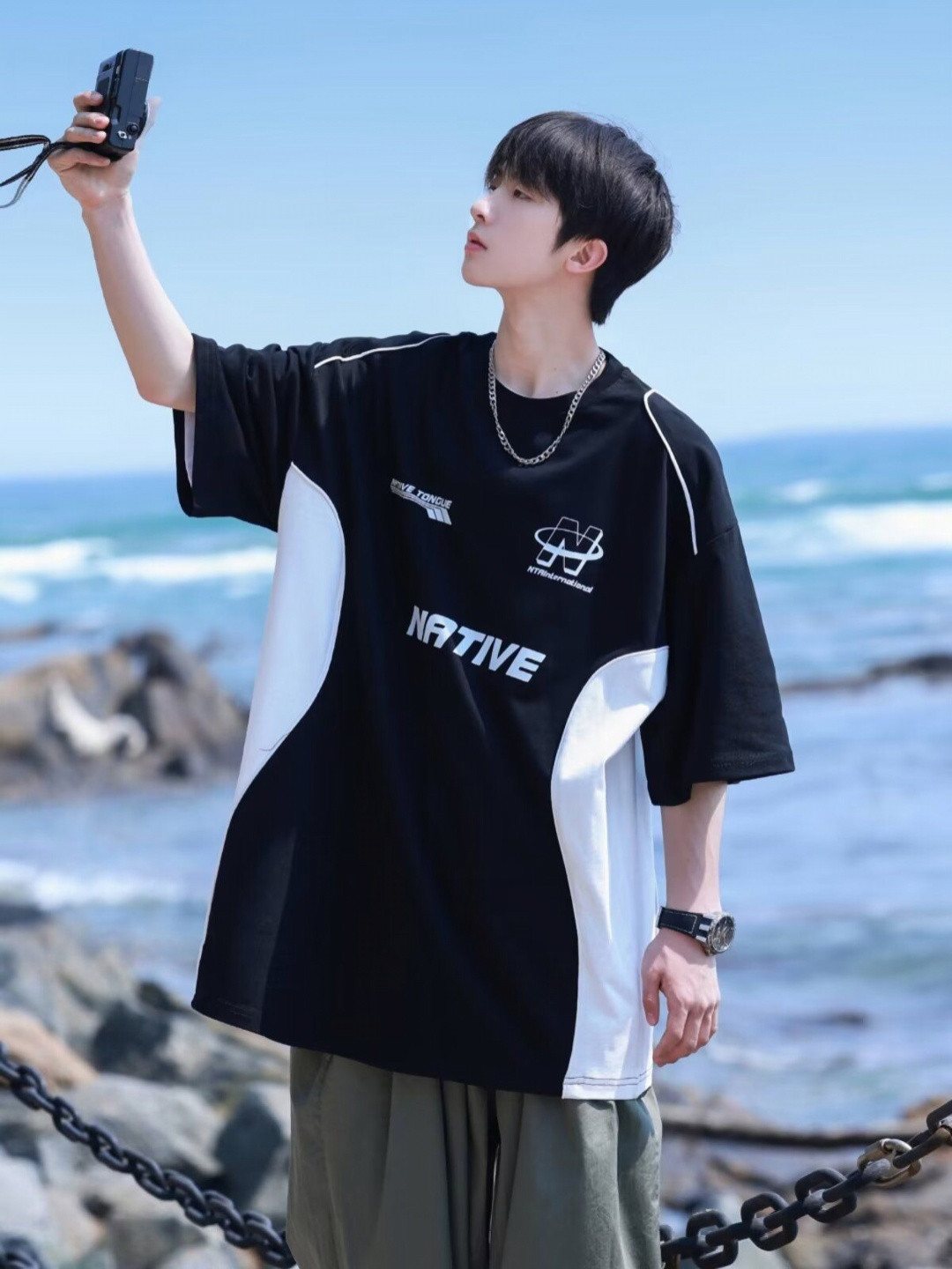 

StyleCast x Revolte Men Typography Printed Round Neck Oversized T-shirt, Black