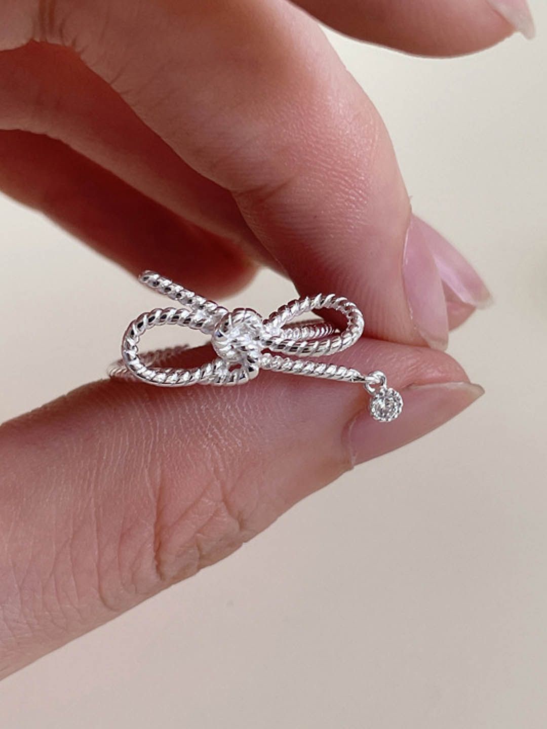 

StyleCast Elegant Silver-Toned Artificial Stone-Studded Knot Shaped Finger Ring