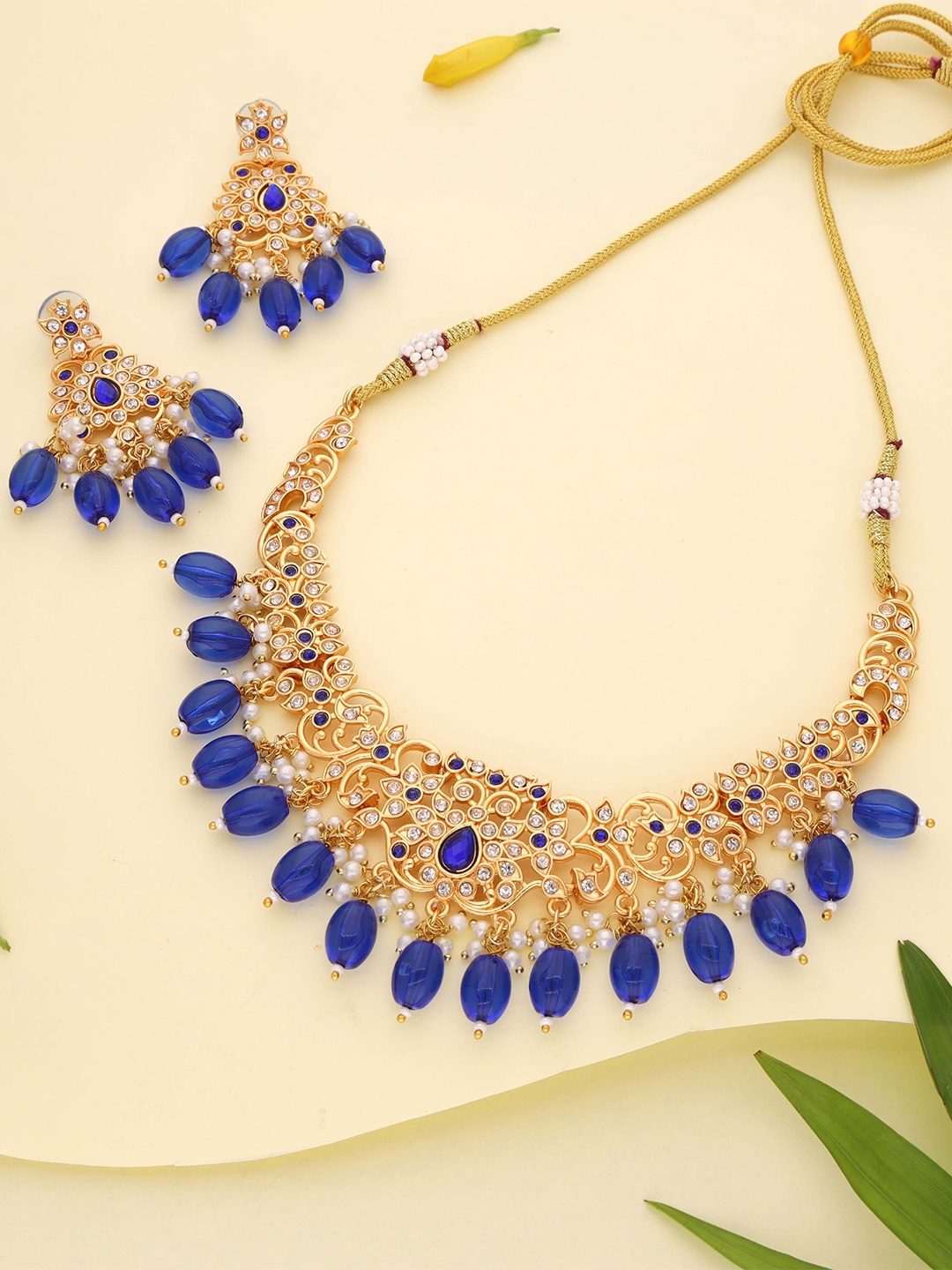 

Lyriss Gold-Plated American Diamond Studded & Beaded Jewellery Set