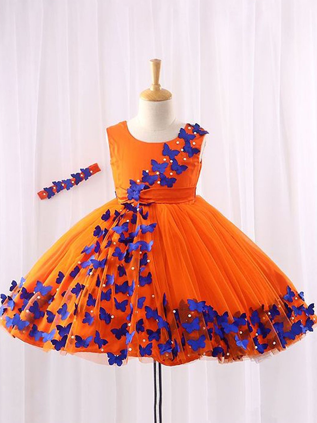 

Li & Li Boutique Girls Tangerine Orange Frock With Spreaded Blue Butterflies