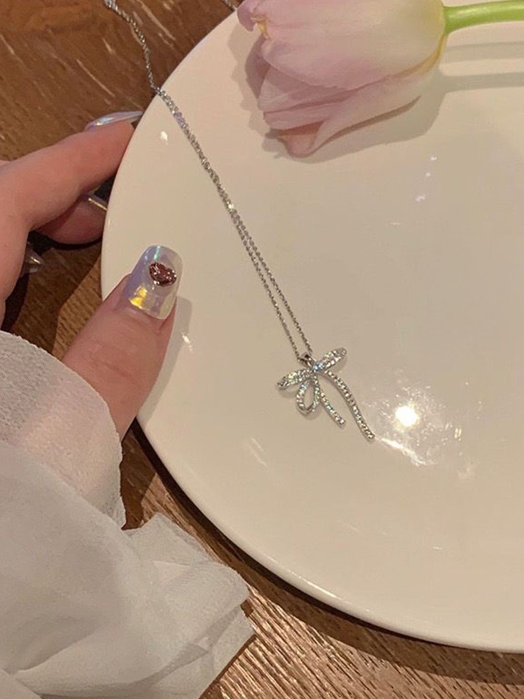 

StyleCast Silver-Toned Stone-Studded Bow Knot Shaped Pendant With Chain