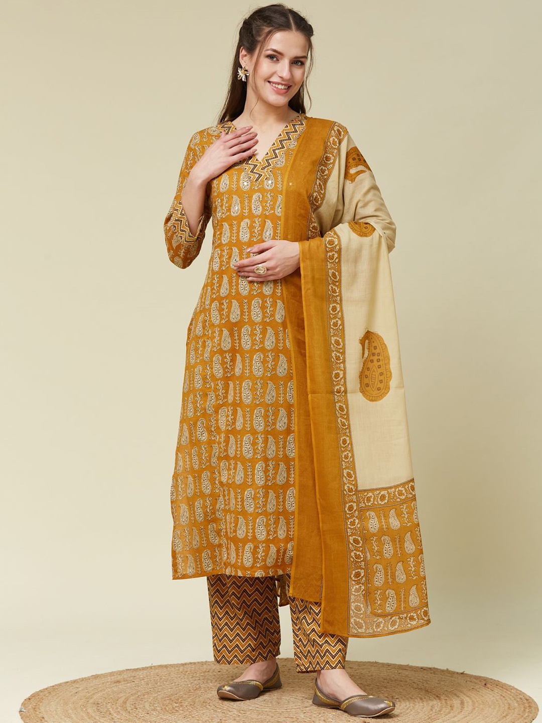 

Colors of Earth Paisley Printed V-Neck Mirror Work Kurta With Trousers And Dupatta, Mustard