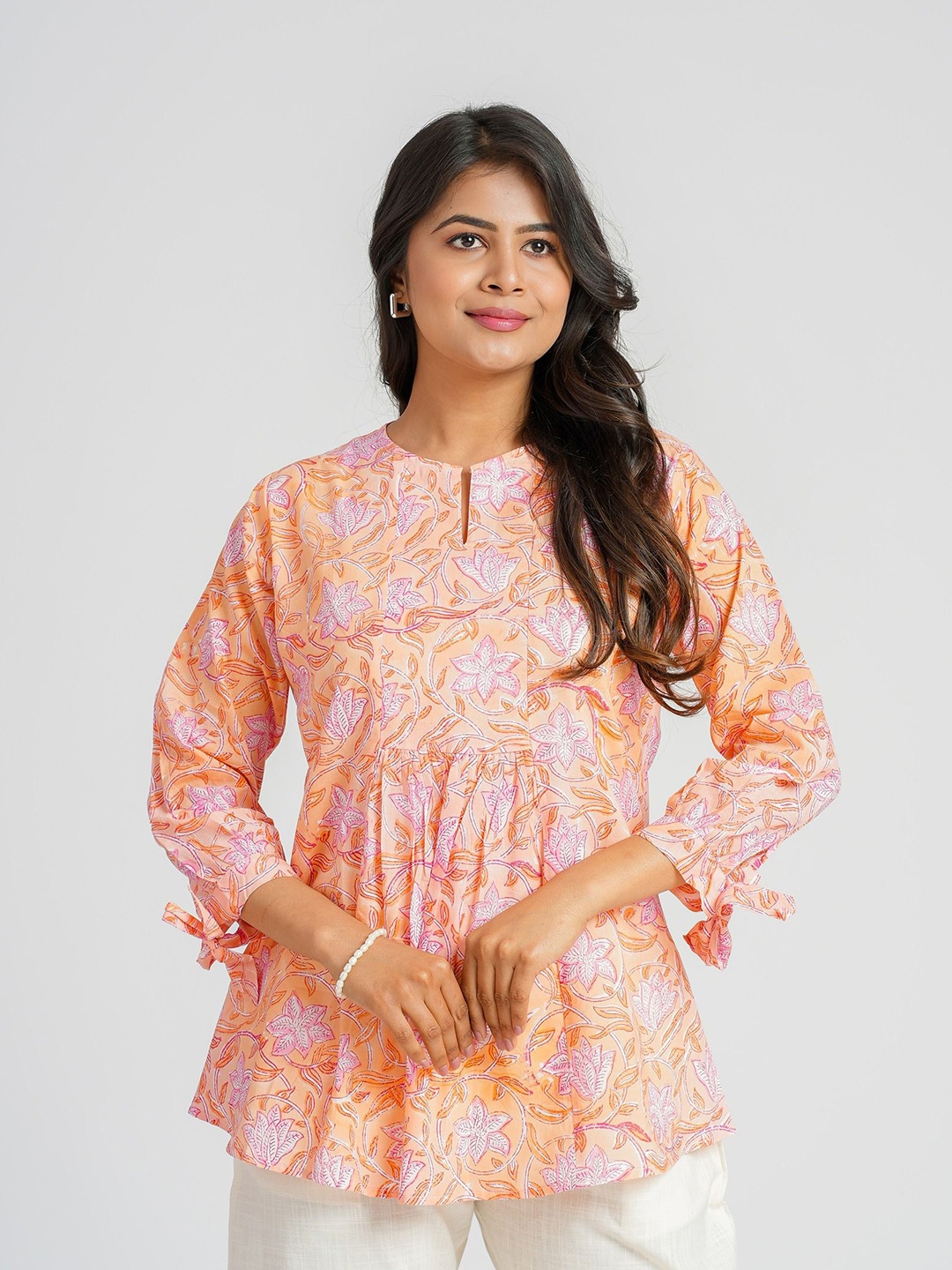 

Cotton Curio Women Floral Block Printed Puff Sleeve Cotton Empire Longline Top, Peach