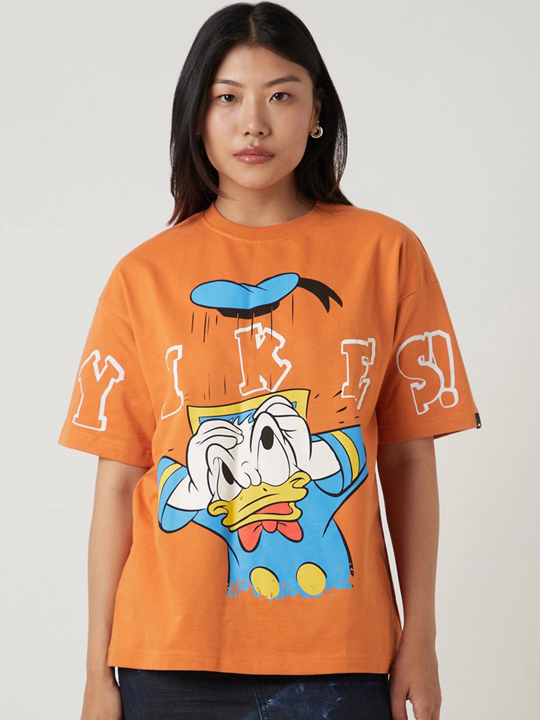 

Bewakoof Heavy Duty Women Donald Duck Graphic Printed Round Neck Cotton Oversized T-shirt, Orange
