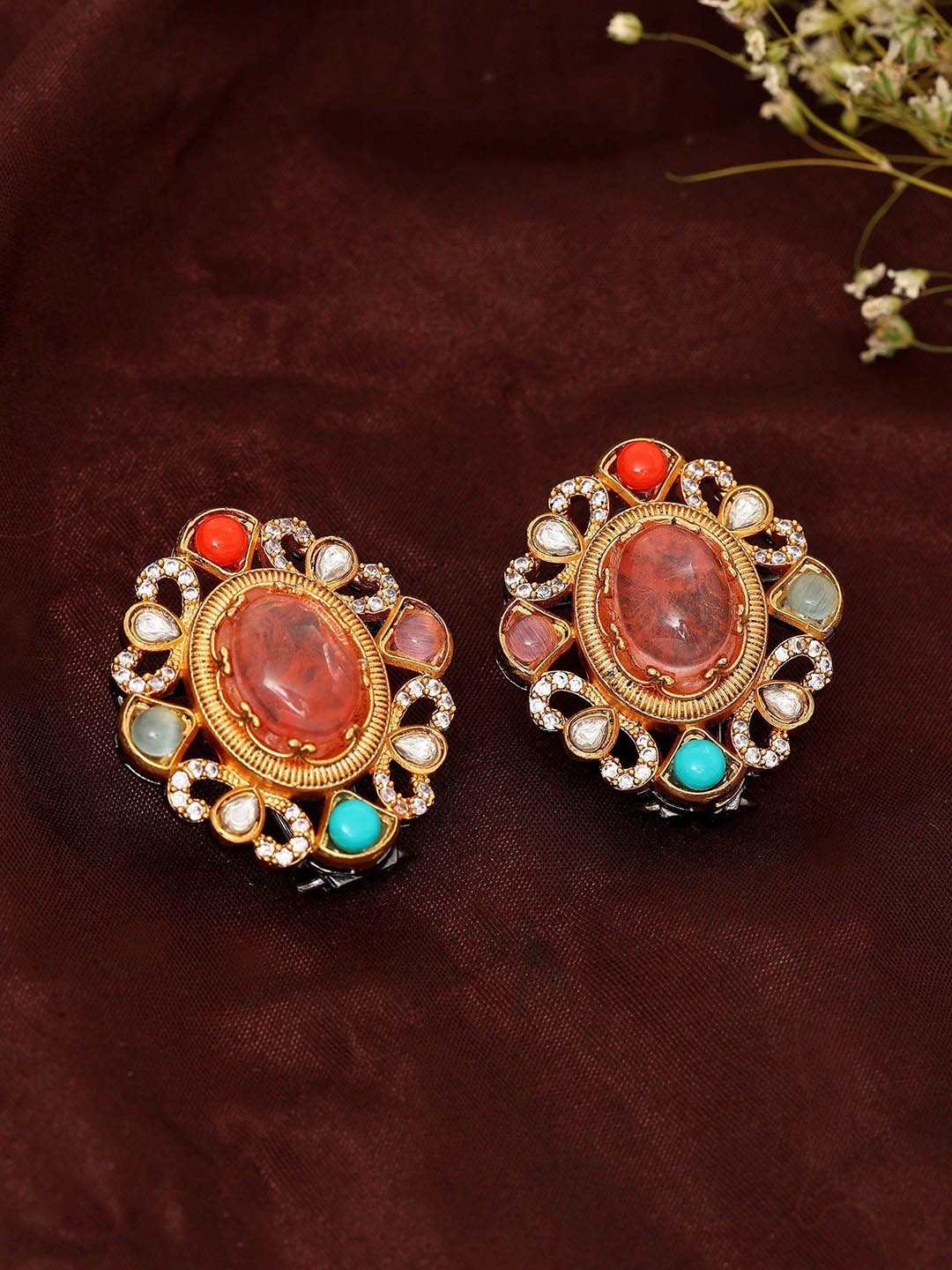 

Exotic India Gold-Plated Artificial Stone Studded Oval Studs Earrings