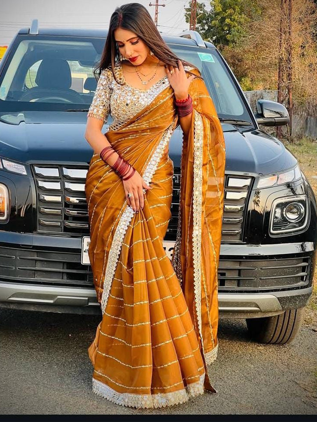 

MANSUBHA Striped Embellished Mirror Work Tissue Saree, Mustard