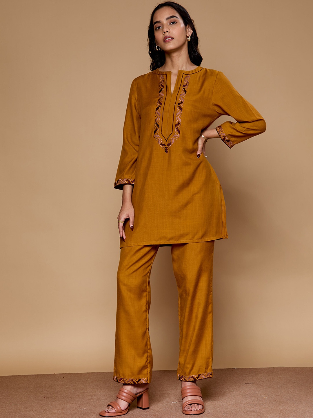 

Saaki Women Ethnic Motifs Embroidered Regular Thread Work Kurti with Trousers, Mustard