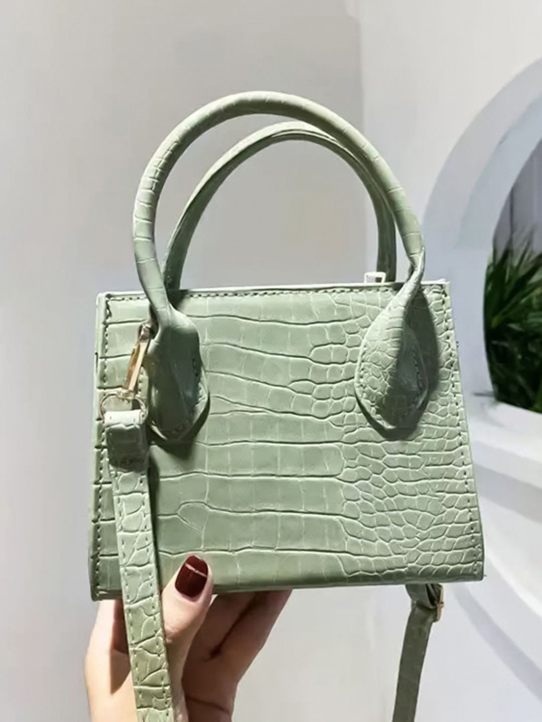 

HAUTE SAUCE by Campus Sutra Textured PU Structured Handheld Bag with Tasselled, Green