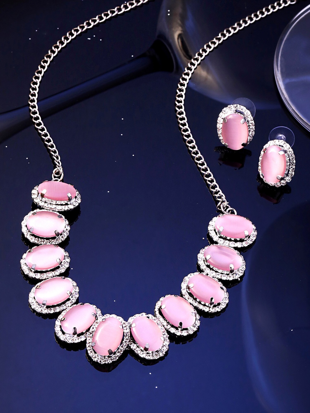 

Yellow Chimes Pink Stone & White Crystal Studded Oval Designed Jewellery Set, Silver