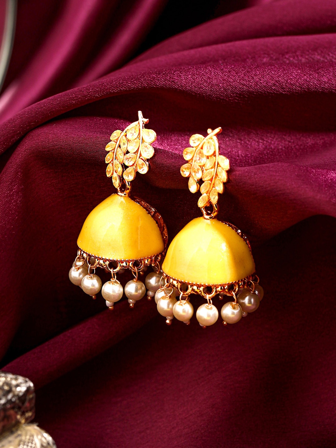 

Yellow Chimes Yellow Leaf Designed Enamelled Jhumka Earrings