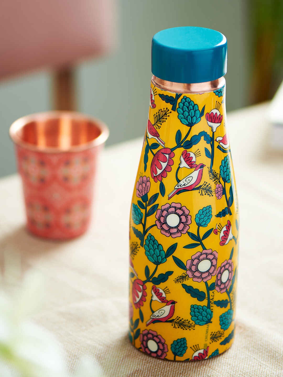 

Chumbak Bloomin Yellow & Turquoise Blue Printed Copper Water Bottle