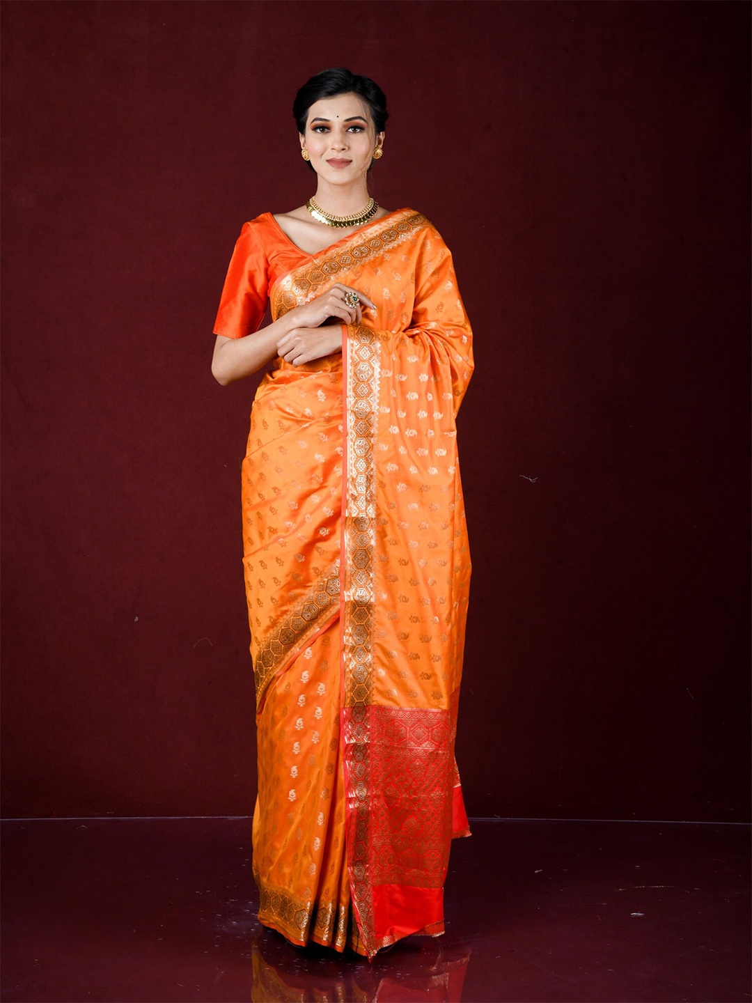 

Exclusiva Orange & Red Woven Design Zari Silk Blend Banarasi Saree