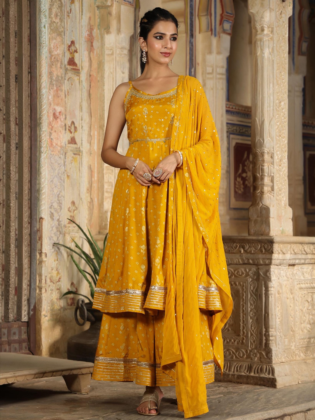 

SCAKHI Women Mustard Yellow Bandhani Printed Layered Gotta Patti Kurti with Sharara & With Dupatta