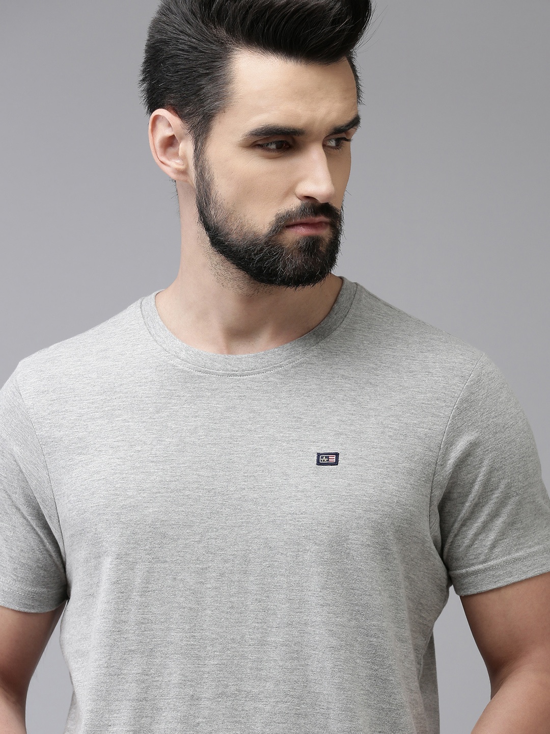 

Arrow Men Grey Melange Solid Round Neck Pure Cotton Brand Logo Applique Knitted T-shirt