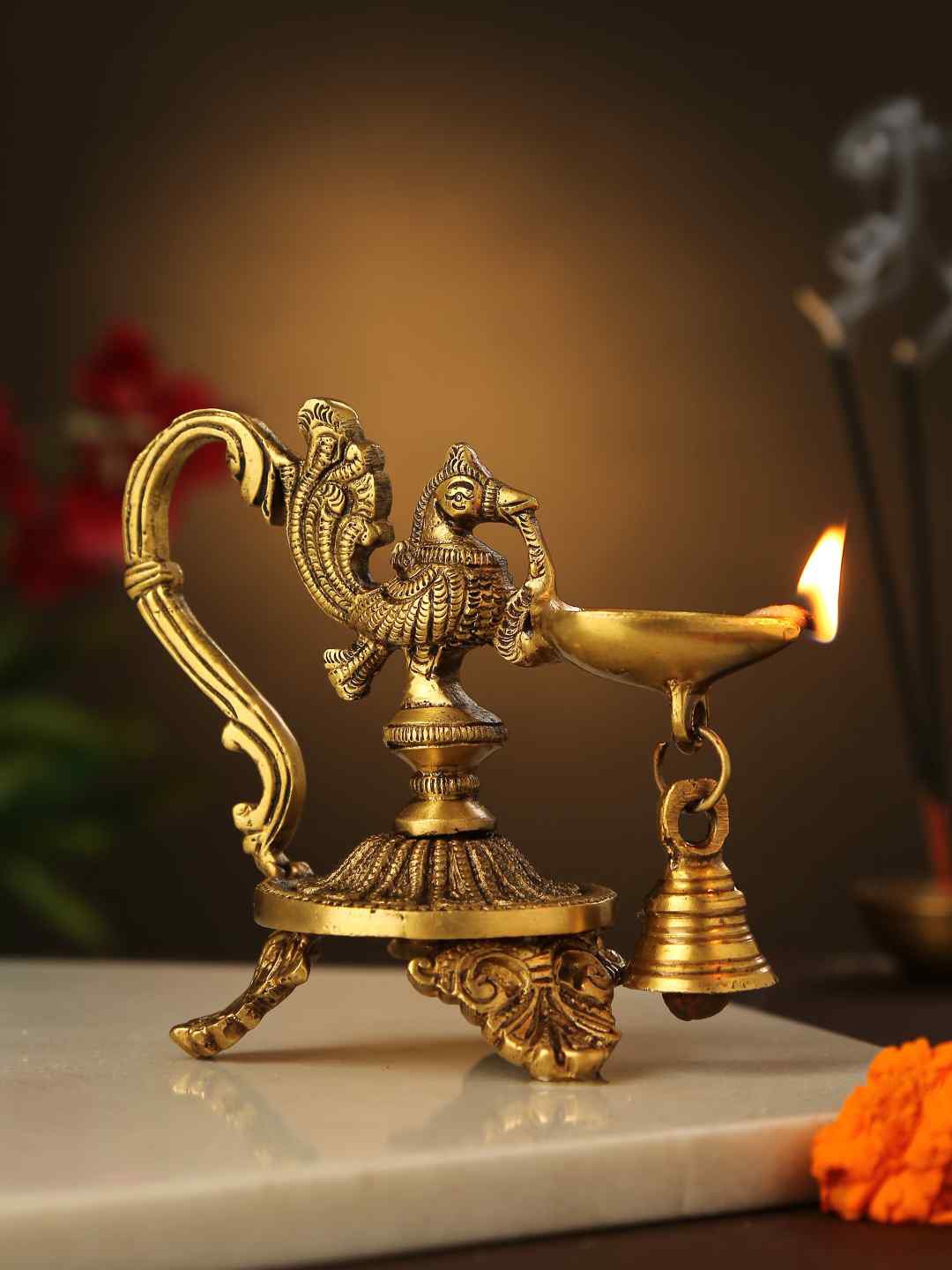 

Amoliconcepts Gold-Toned Peacock Shaped Lamp Diya with Bell Pooja Essentials