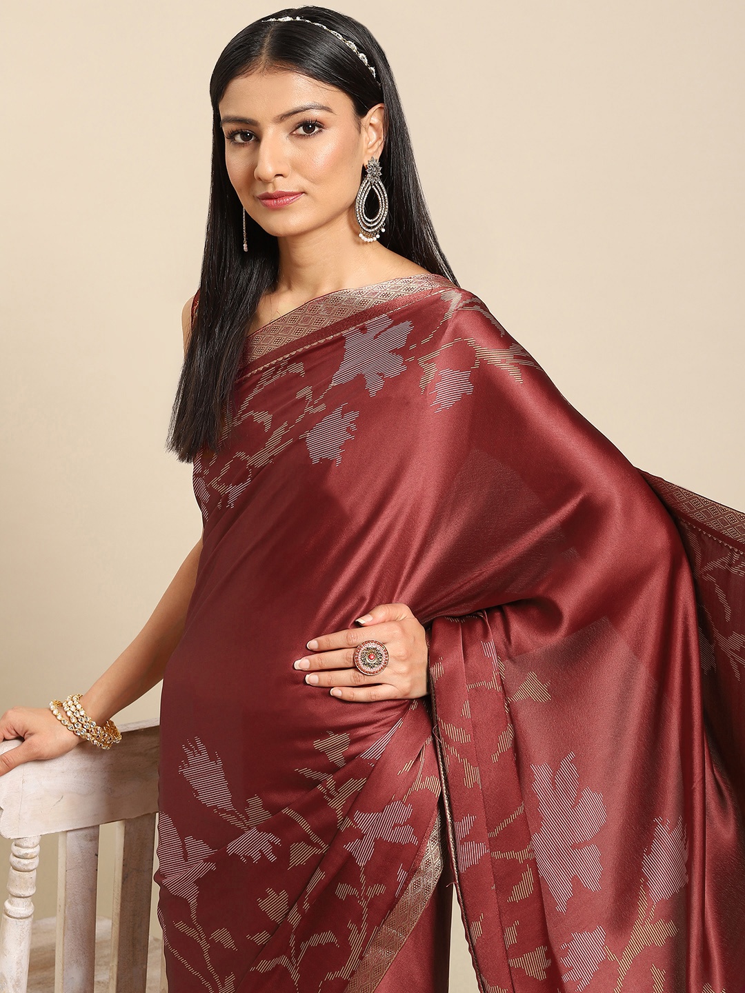 

Nimayaa Maroon Ethnic Motifs Satin Saree