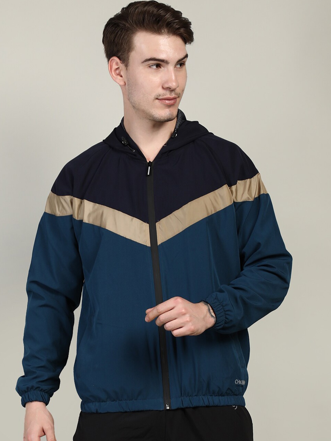 

CHKOKKO Men Navy Blue Teal Colourblocked Windcheater Outdoor Sporty Jacket