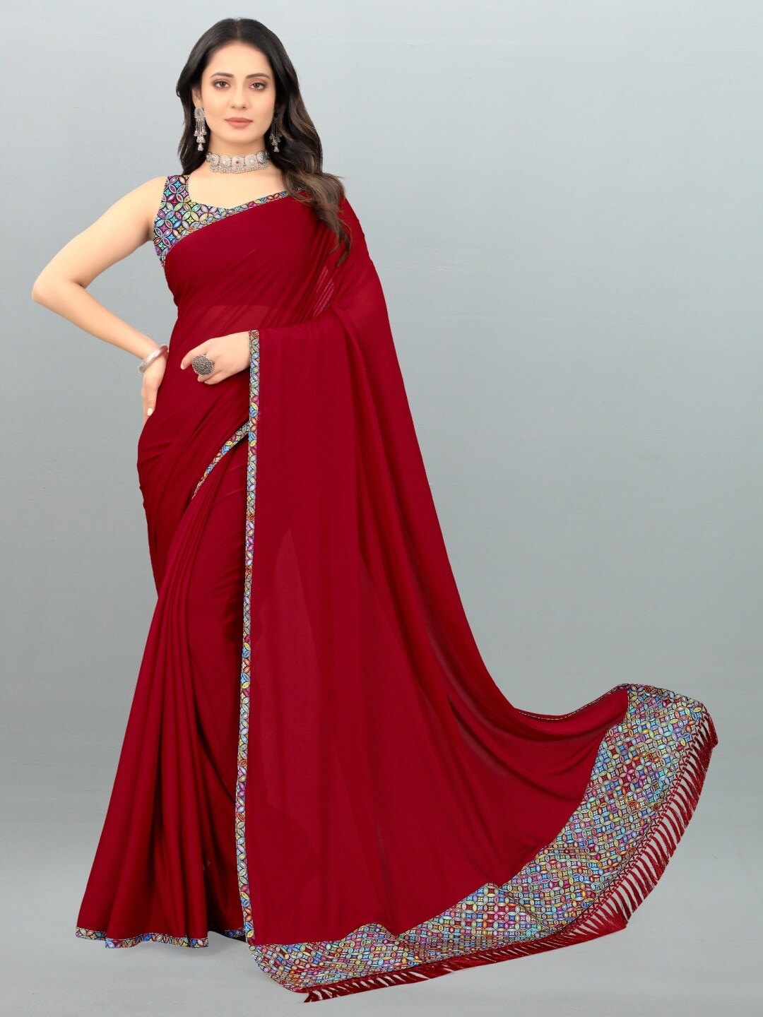 

APNISHA Women Red & Blue Solid Lycra Saree