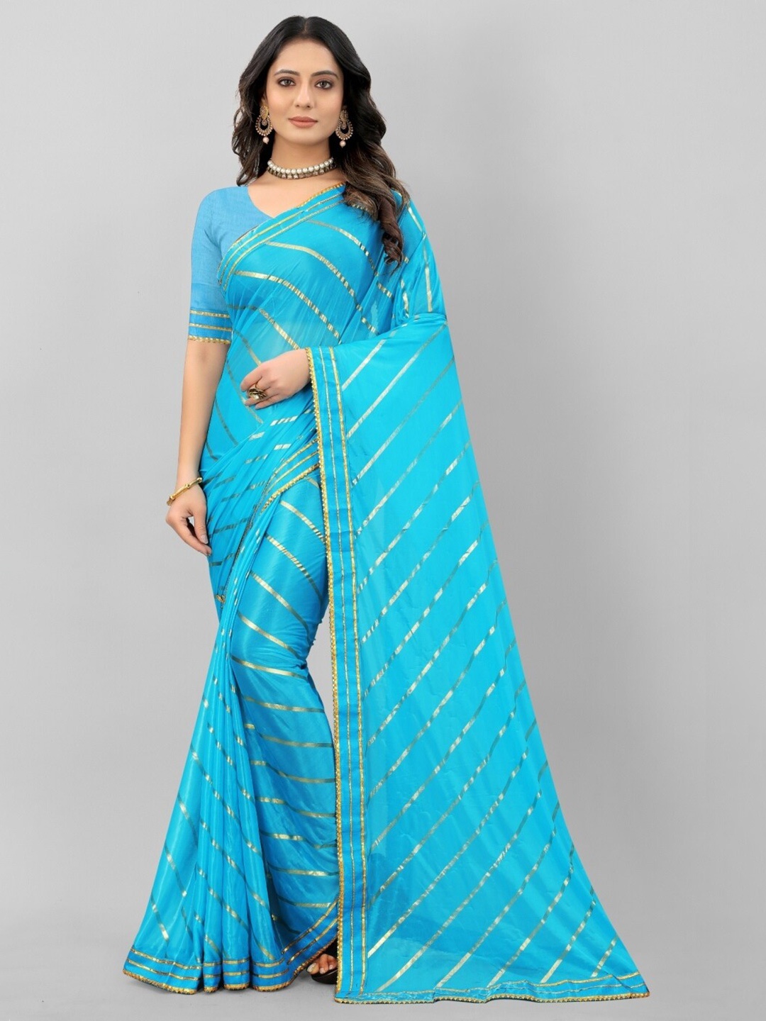 

APNISHA Women Blue & Gold-Toned Embellished Saree