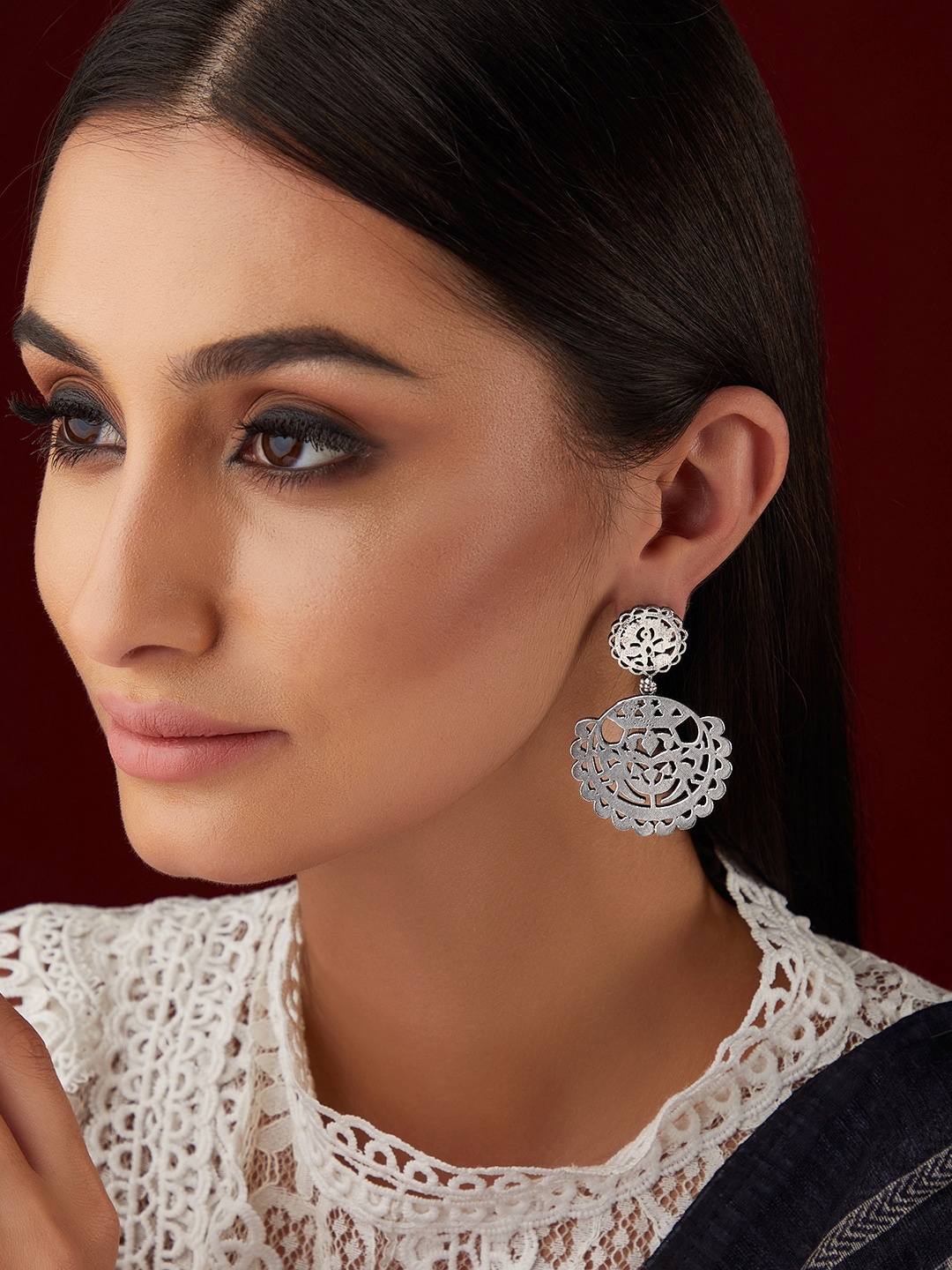 

Rubans Oxidised Silver Plated Drop Earrings With Elegantly Carved Design