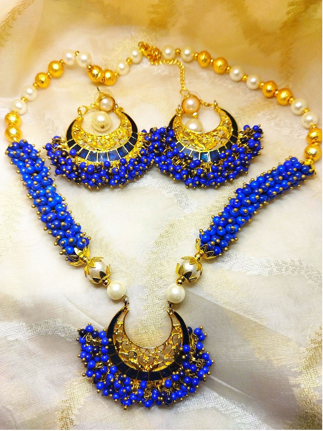 

Kshitij Jewels Gold-Plated White & Navy Blue Stone-Studded & Pearl Beaded Jewellery Set