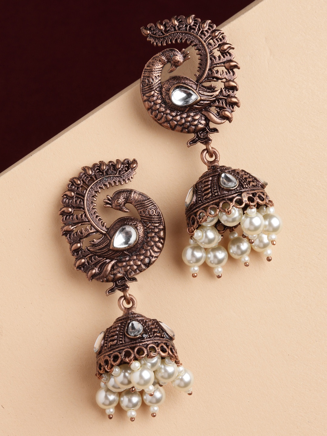 

PANASH Copper-Toned Peacock Shaped Jhumkas Earrings