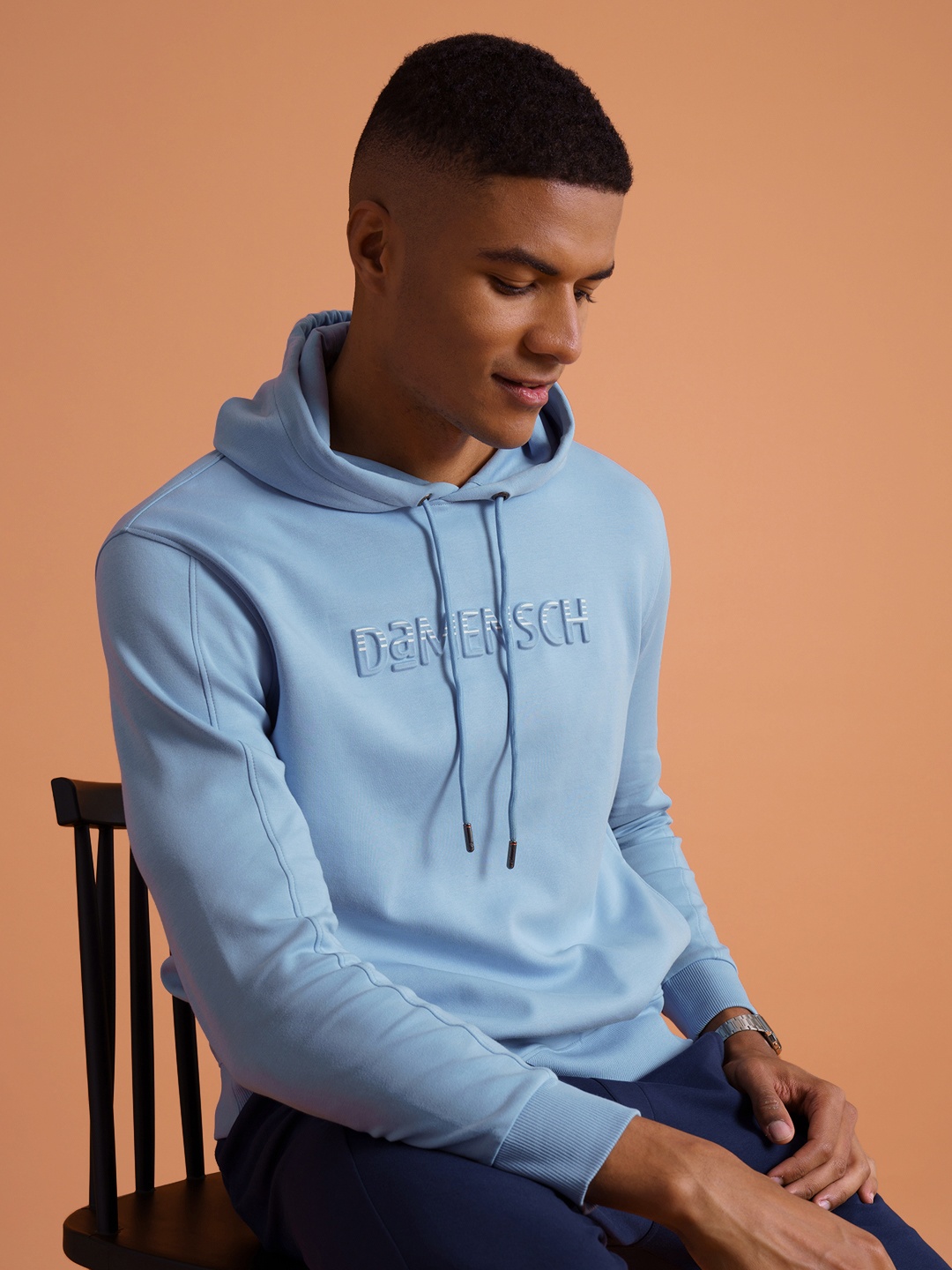 

DAMENSCH Men Solid Blue Cotton Regular Fit DAM Logo Hoodie