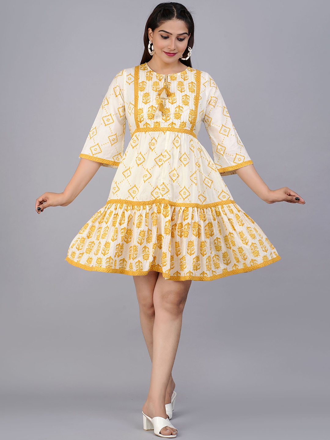 

PREKSHA Yellow Ethnic Motifs Printed Tie-Up Neck Cotton A-Line Dress