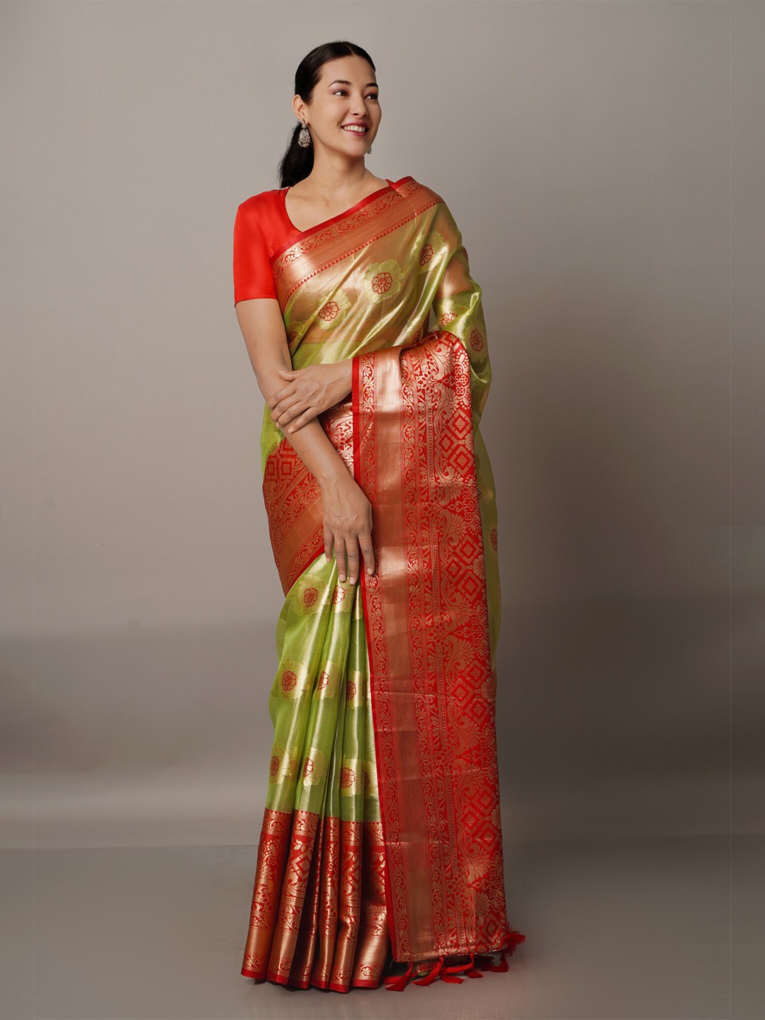 

Unnati Silks Green & Orange Ethnic Motifs Zari Organza Banarasi Saree