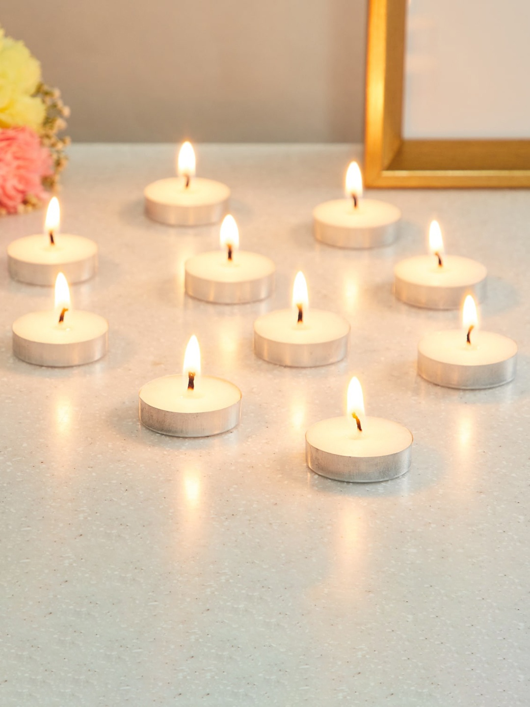 

Home Centre Set of 10 White Solid Lily Scented T-Light Candles