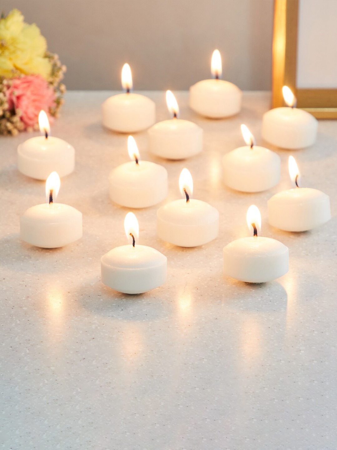 

Home Centre Set of 12 Off-White Solid Round Vanilla-Scented Floating Candles