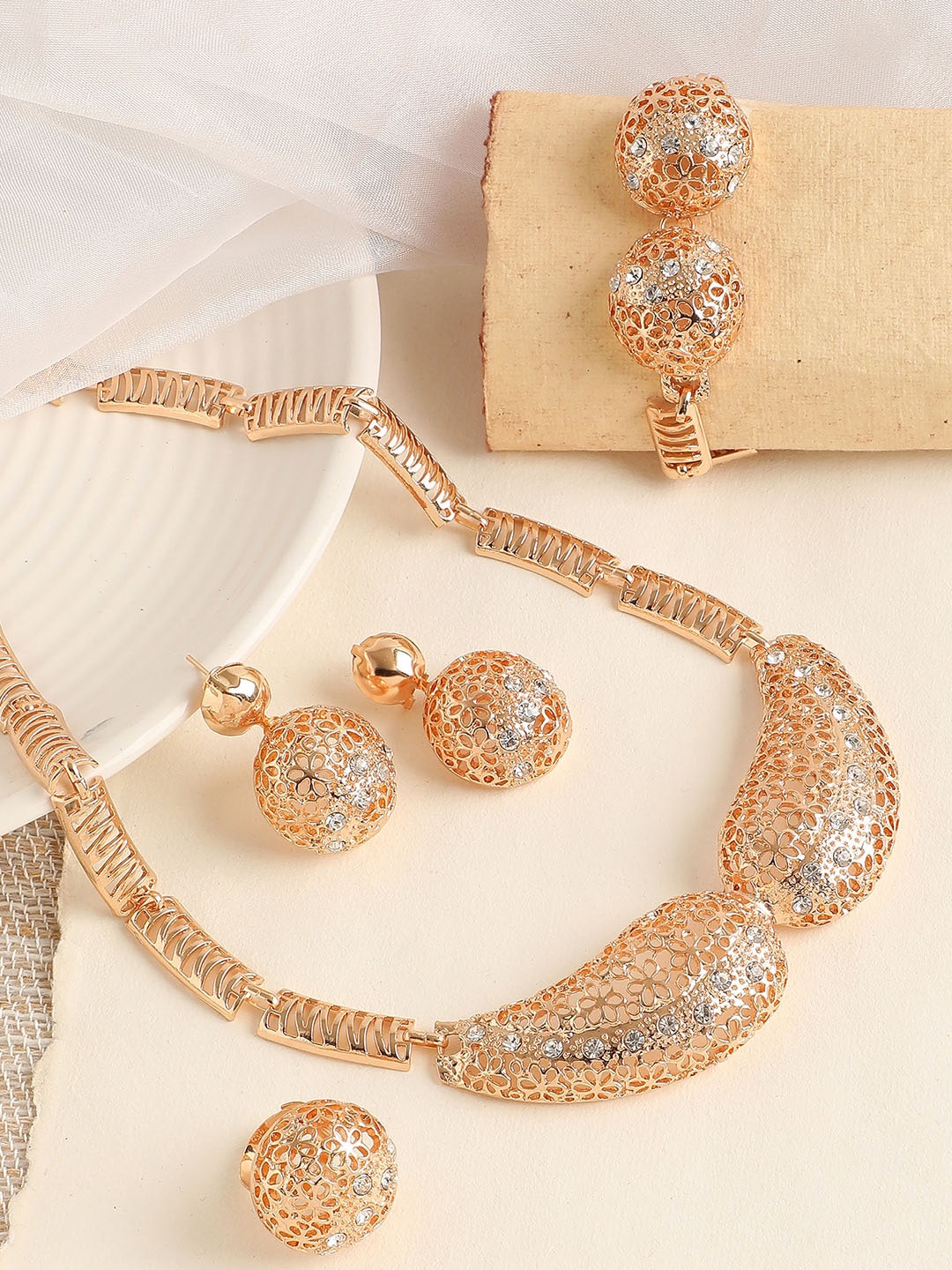 

SOHI Women Gold-Plated & Toned White Artificial Stones Studded Jewellery Set