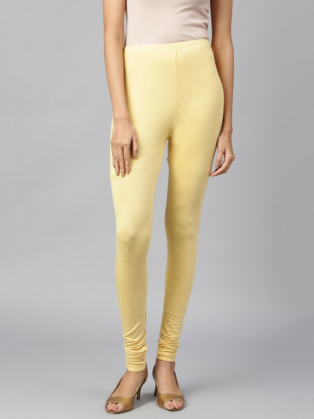 

elleven Women Yellow Solid Churidar-Length Leggings