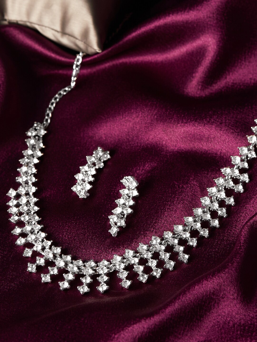 

Anouk Women Silver Coloured Silver-Plated American-Daimond Studded Jewellery Set