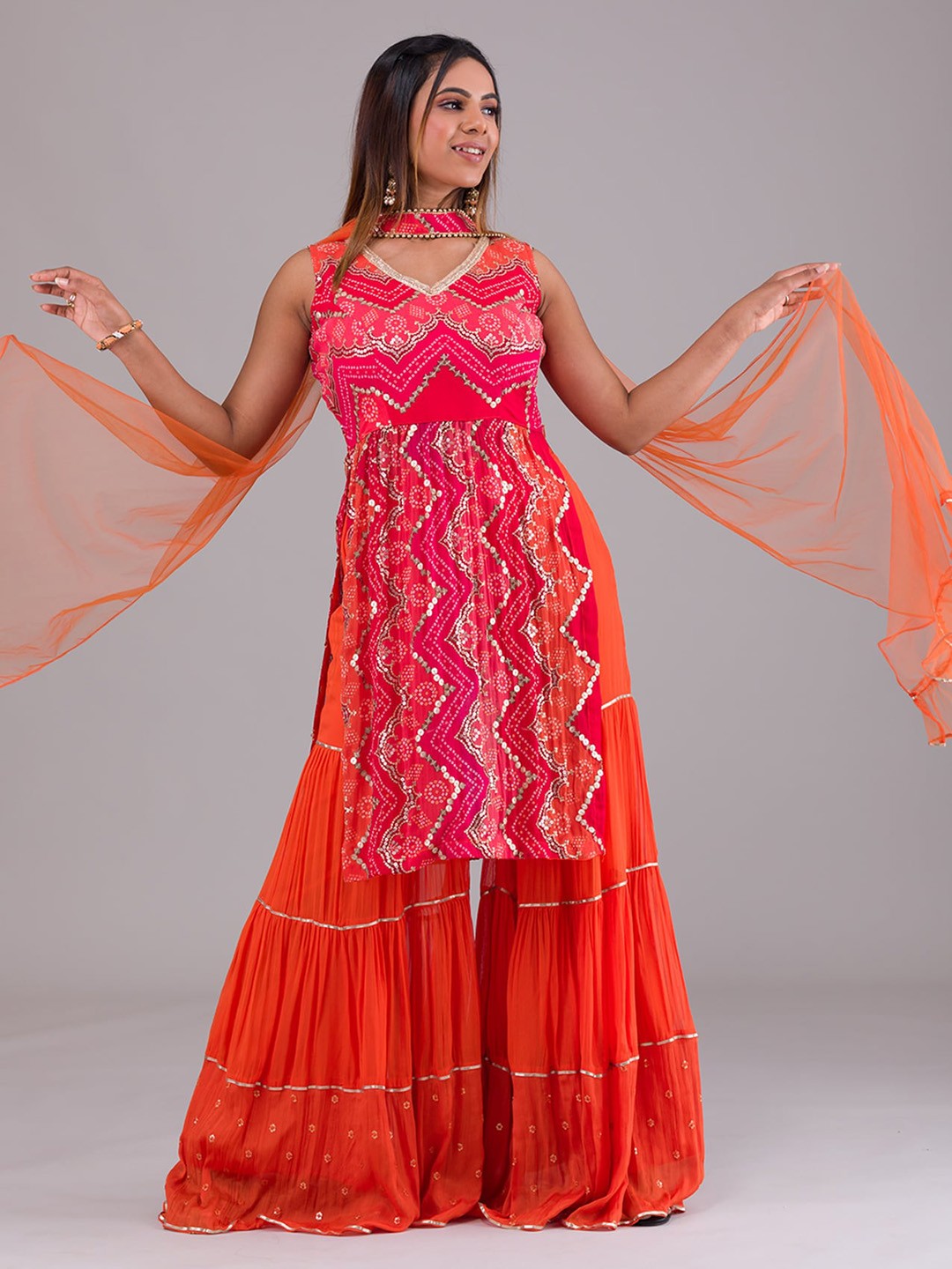 

Koskii Women Orange Bandhani Printed Pleated Sequinned Kurta with Sharara & With Dupatta