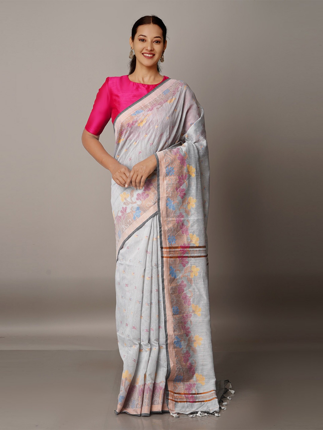 

Unnati Silks White & Blue Floral Zari Silk Cotton Jamdani Saree