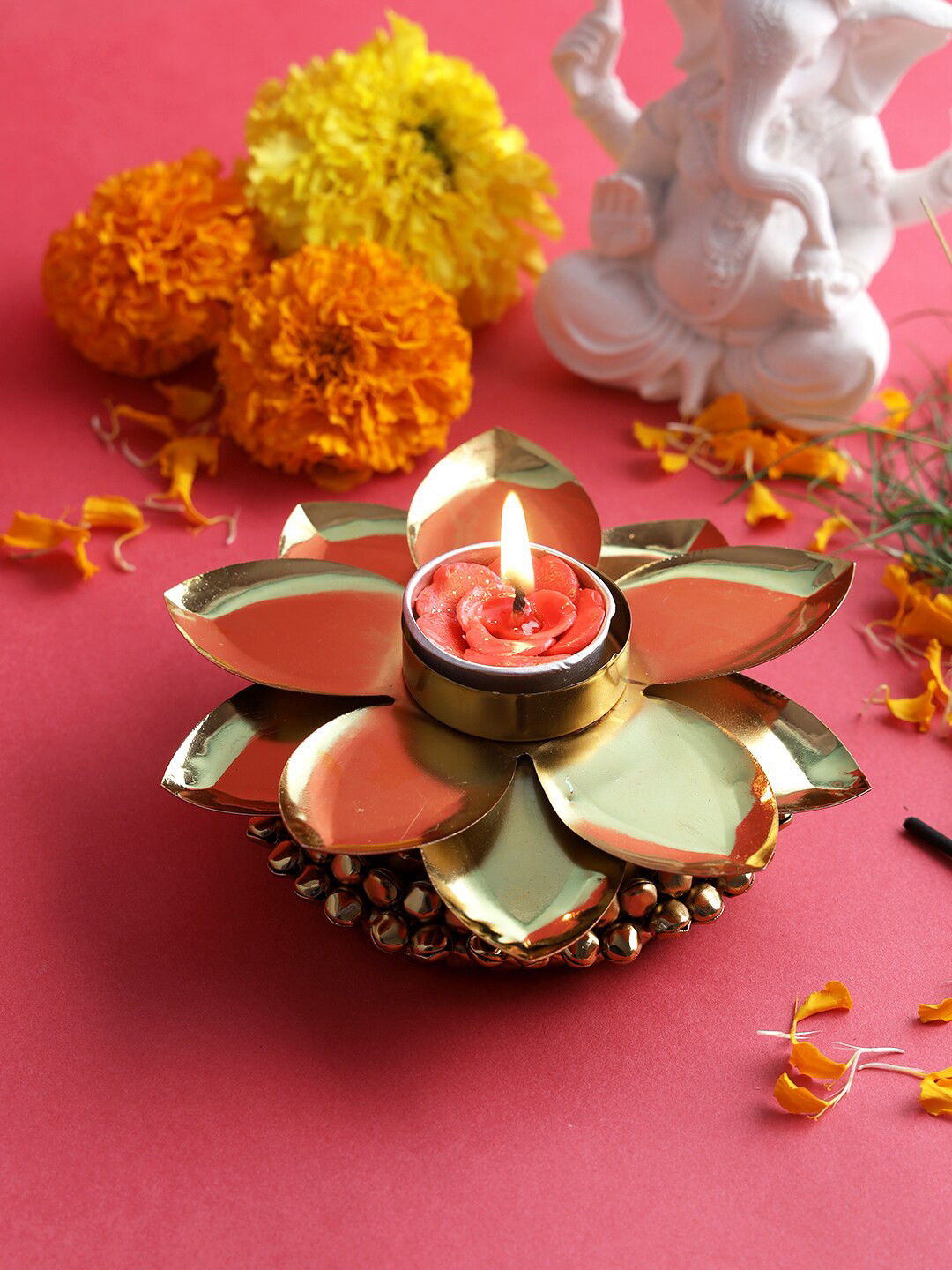 

Aapno Rajasthan Gold Toned Flower Design Diya With Candle
