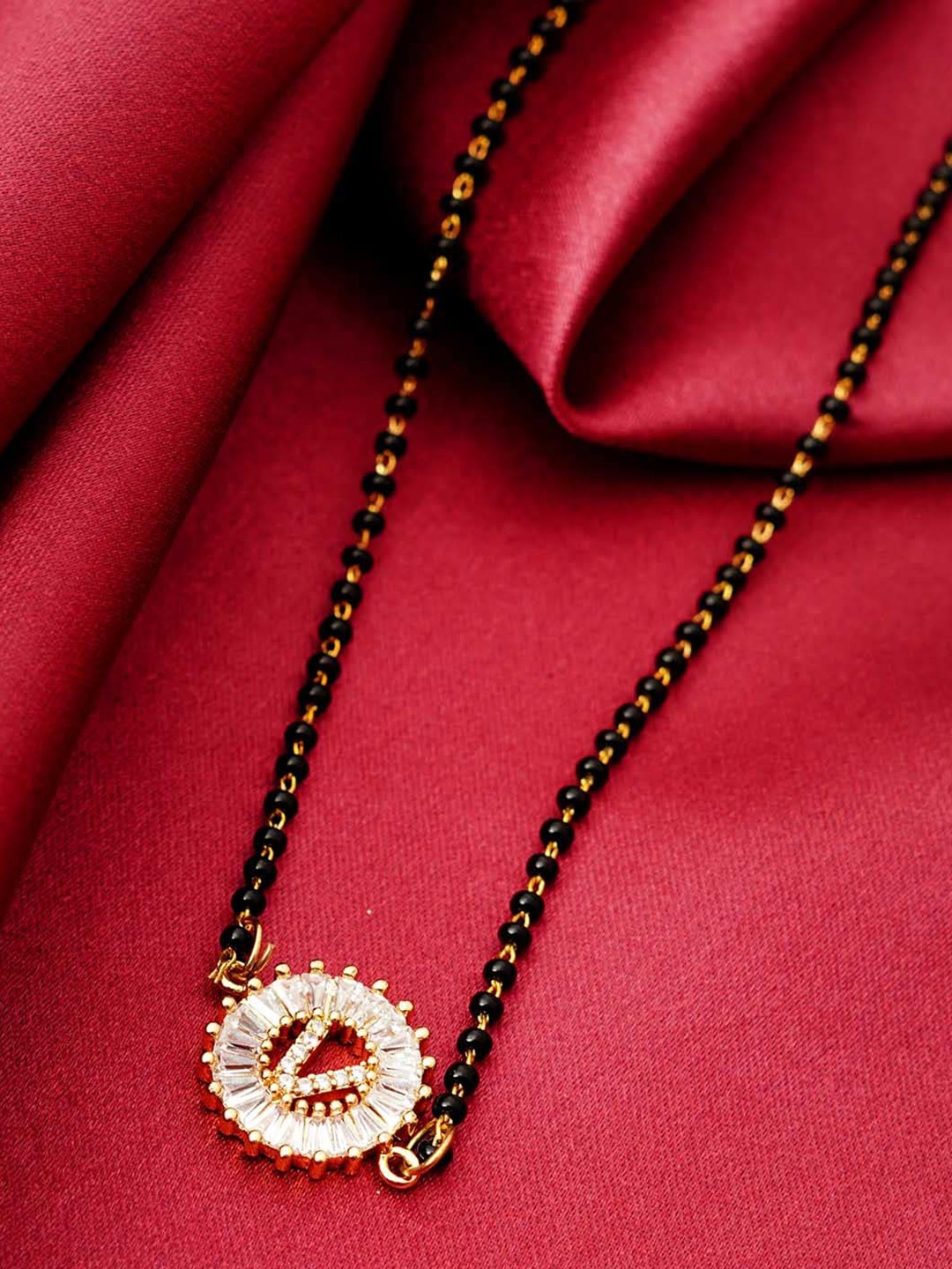 

Ferosh Black & White Gold-Plated Stone Studded & Beaded V Alphabet Mangalsutra